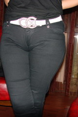 Tight black pants show a porky cameltoe